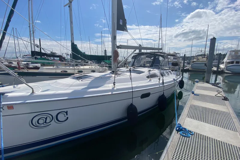 Slide: The Image of 2003 Hunter 386 sailboat docked at marina under clear blue sky. - 81