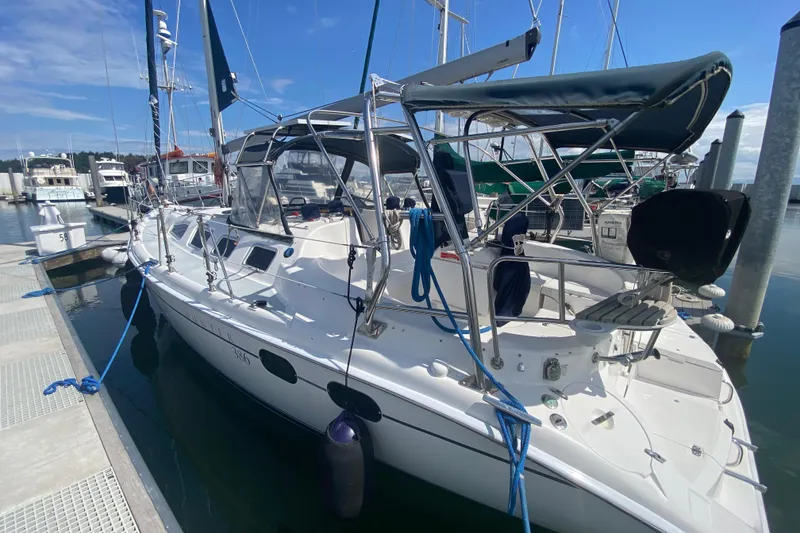 Slide: The Image of 2003 Hunter 386 sailboat docked at marina under clear blue sky. - 83