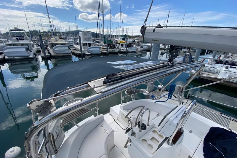 Slide: The Image of 2003 Hunter 386 sailboat docked at marina, featuring cockpit and rigging. - 84