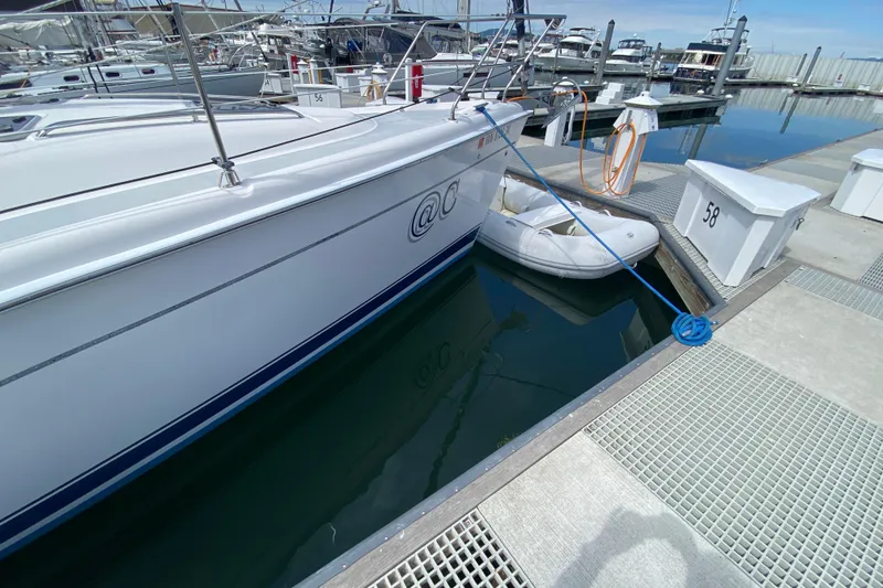 Slide: The Image of Hunter 386 sailboat docked with inflatable dinghy, marina setting, 2003 model. - 86