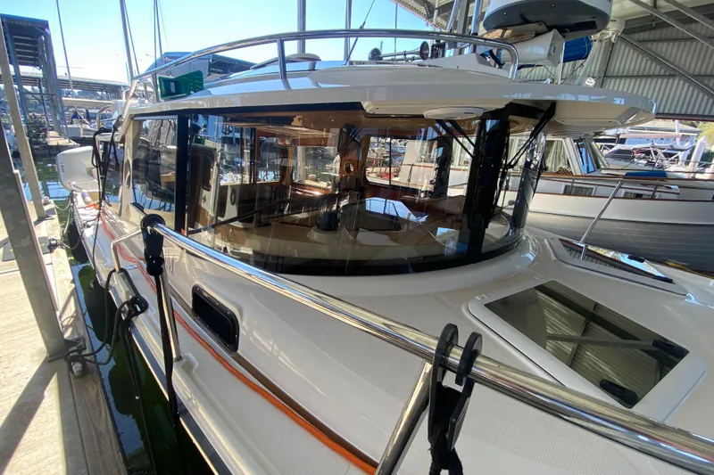Slide: The Image of 2019 Ranger Tugs R-29 S docked in a marina, showcasing sleek design and spacious interior. - 14