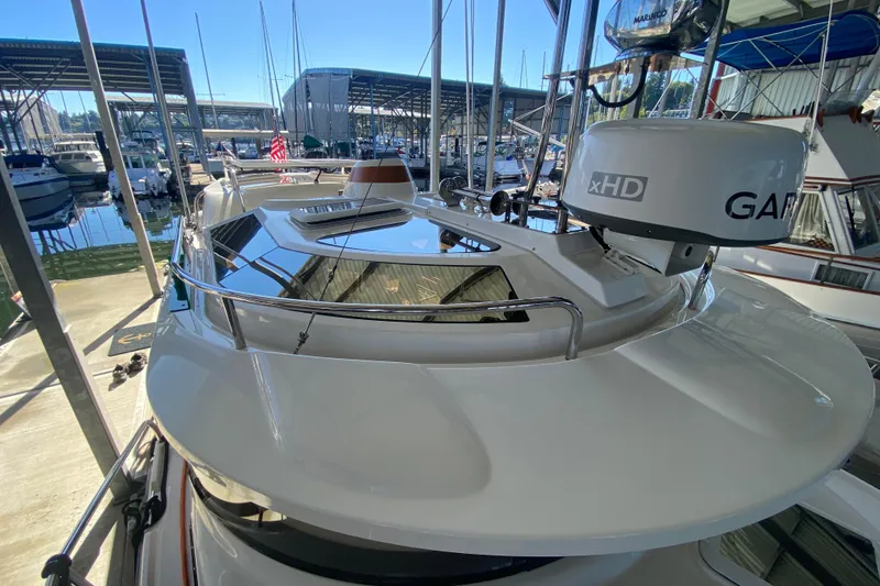 Slide: The Image of 2019 Ranger Tugs R-29 S boat docked in a marina, featuring Garmin xHD radar. - 16