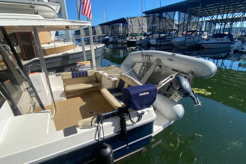 Slide: The Image of 2019 Ranger Tugs R-29 S docked with inflatable boat and American flag. - 20