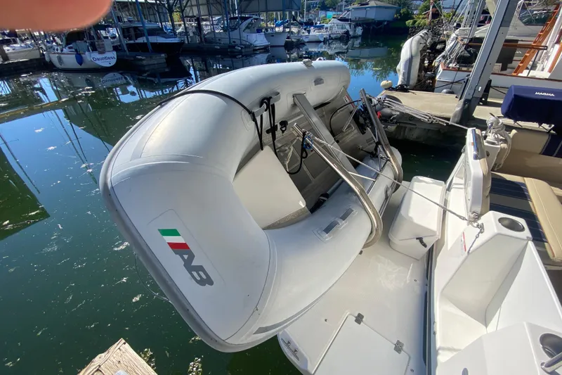 Slide: The Image of 2019 Ranger Tugs R-29 S with inflatable dinghy docked at marina. - 26