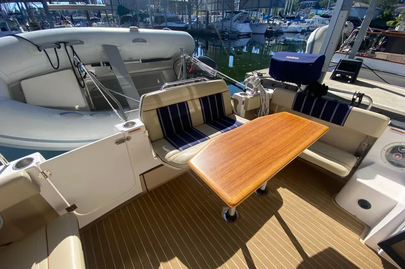 Slide: The Image of 2019 Ranger Tugs R-29 S boat interior with seating and wooden table. - 28