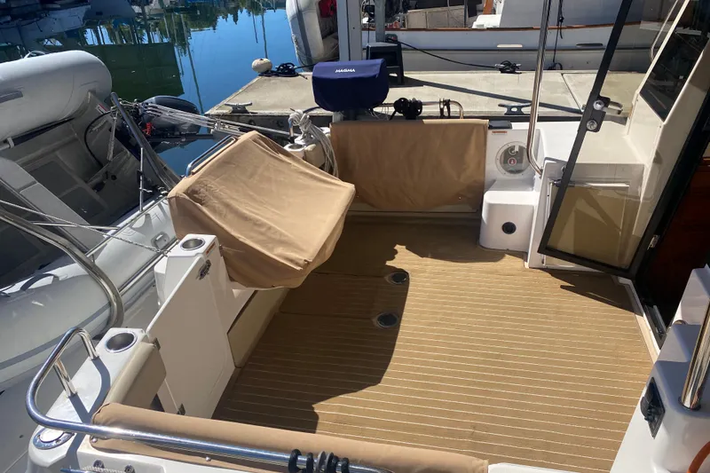 Slide: The Image of 2019 Ranger Tugs R-29 S boat deck with tan seating and striped flooring. - 29