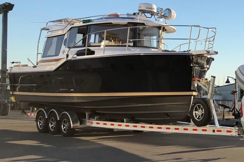 Slide: The Image of 2019 Ranger Tugs R-29 S boat on a trailer at a marina. - 3