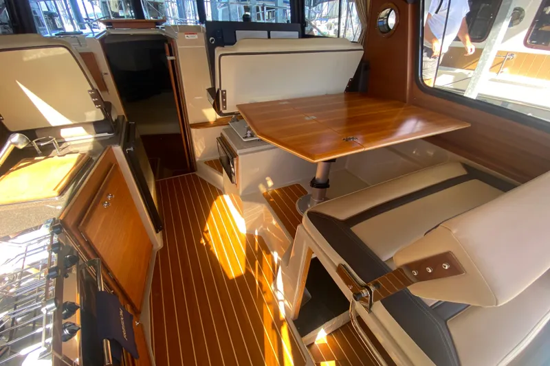 Slide: The Image of 2019 Ranger Tugs R-29 S interior with wood accents and dining area. - 41