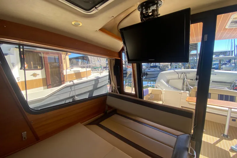 Slide: The Image of Interior of 2019 Ranger Tugs R-29 S with TV and marina view. - 45