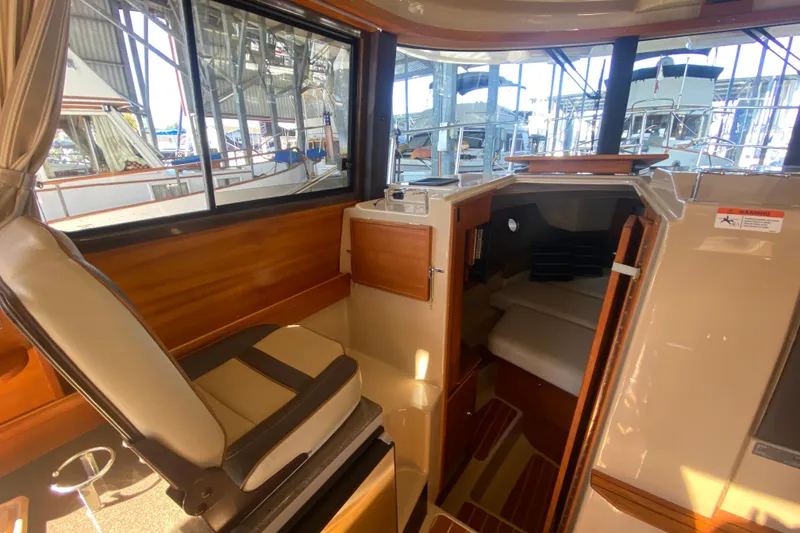 Slide: The Image of 2019 Ranger Tugs R-29 S interior cabin with seating and sleeping area. - 46
