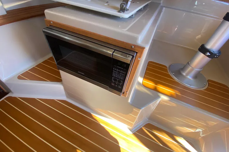 Slide: The Image of 2019 Ranger Tugs R-29 S interior with microwave and wood flooring. - 47