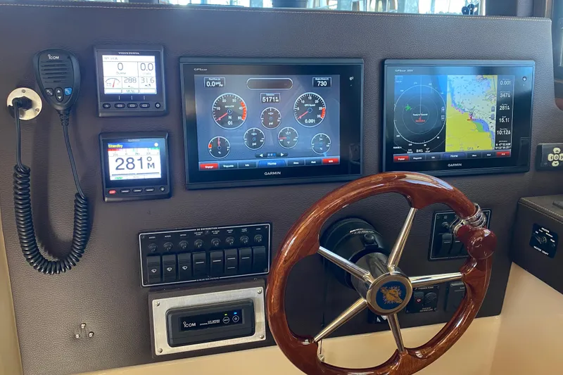 Slide: The Image of 2019 Ranger Tugs R-29 S helm with Garmin displays and wooden steering wheel. - 50