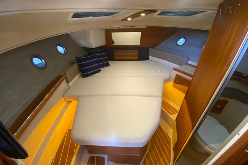 Slide: The Image of 2019 Ranger Tugs R-29 S cabin interior with cozy bed and ambient lighting. - 62