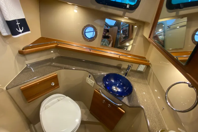 Slide: The Image of 2019 Ranger Tugs R-29 S bathroom with modern fixtures, blue sink, and nautical decor. - 66