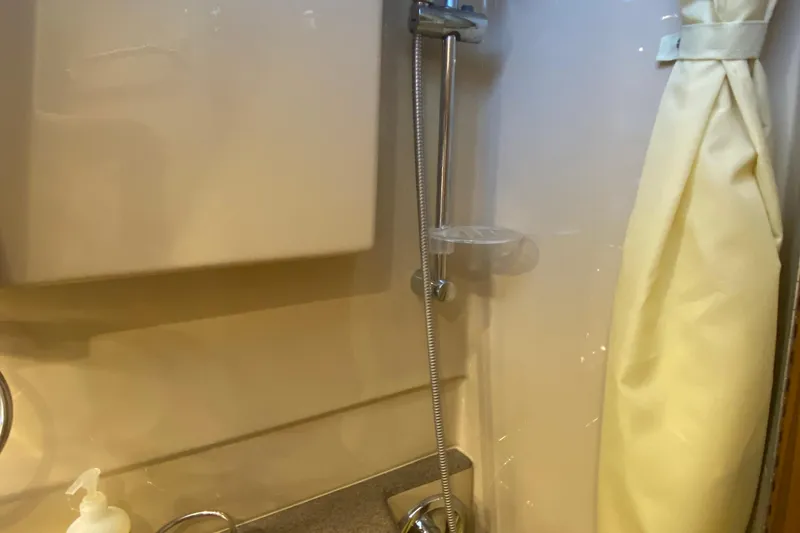 Slide: The Image of 2019 Ranger Tugs R-29 S bathroom with showerhead and curtain. - 67