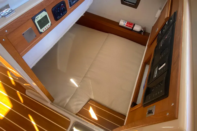 Slide: The Image of 2019 Ranger Tugs R-29 S interior cabin with control panels and fire extinguisher. - 69
