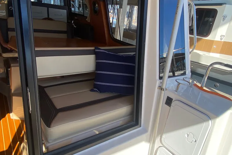 Slide: The Image of 2019 Ranger Tugs R-29 S interior with seating and striped cushion. - 71