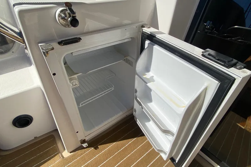 Slide: The Image of Open refrigerator on 2019 Ranger Tugs R-29 S boat, showing interior shelves and door compartments. - 72