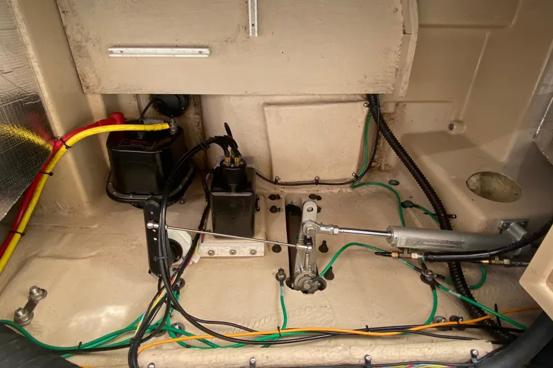 Slide: The Image of 2019 Ranger Tugs R-29 S engine compartment with wiring and hydraulic components. - 81