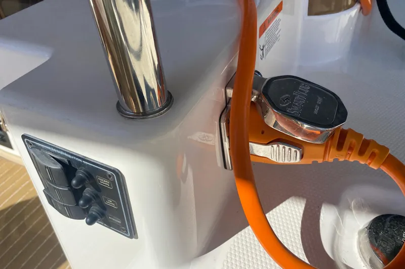 Slide: The Image of 2019 Ranger Tugs R-29 S boat electrical connection with orange power cable. - 86
