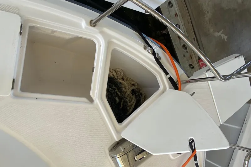 Slide: The Image of Open storage compartment on 2019 Ranger Tugs R-29 S boat, showing ropes inside. - 9