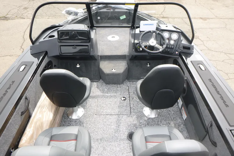 Slide: The Image of 2026 Tracker Targa V-18 WT boat interior with dual seats and steering console. - 4