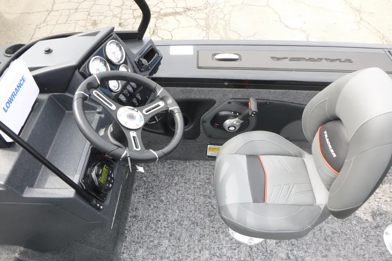 Slide: The Image of 2026 Tracker Targa V-18 WT boat interior with steering wheel and gray seat. - 8