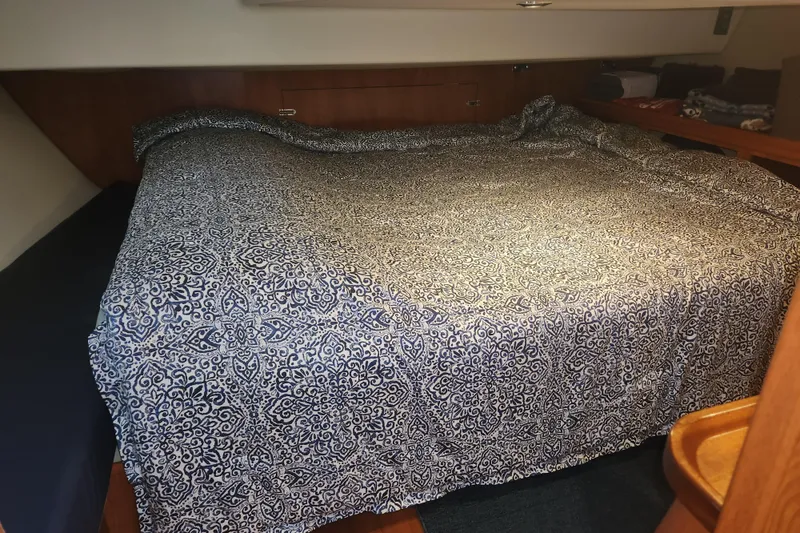 Slide: The Image of Cozy cabin interior of 2011 Hunter 39 sailboat with patterned bedding. - 13