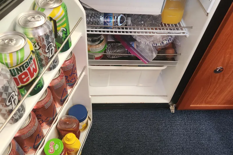Slide: The Image of Refrigerator stocked with drinks and condiments inside a 2011 Hunter 39 boat. - 14