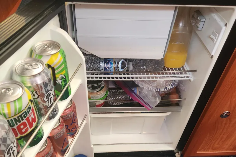 Slide: The Image of Mini fridge stocked with drinks and food, inside a 2011 Hunter 39 boat. - 15