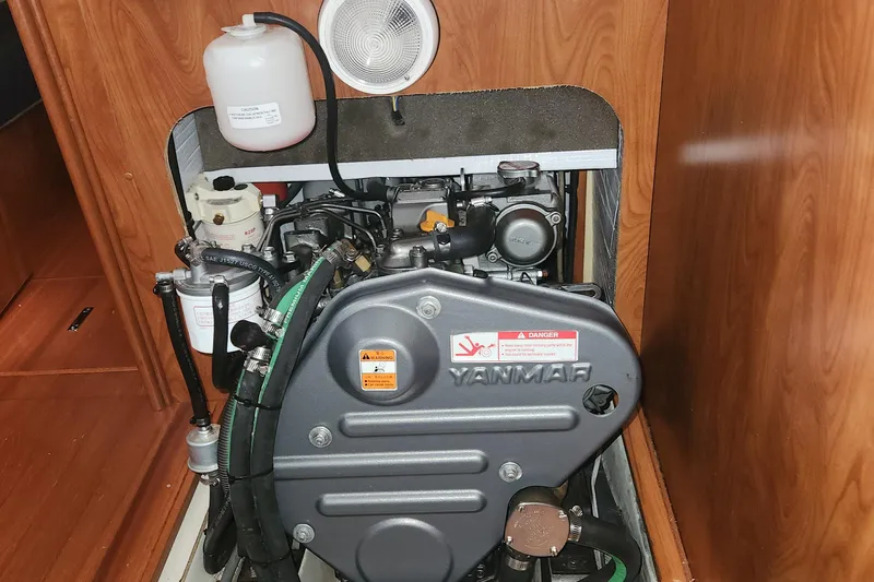 Slide: The Image of Yanmar engine in a 2011 Hunter 39 sailboat, showcasing detailed components and wooden interior. - 18