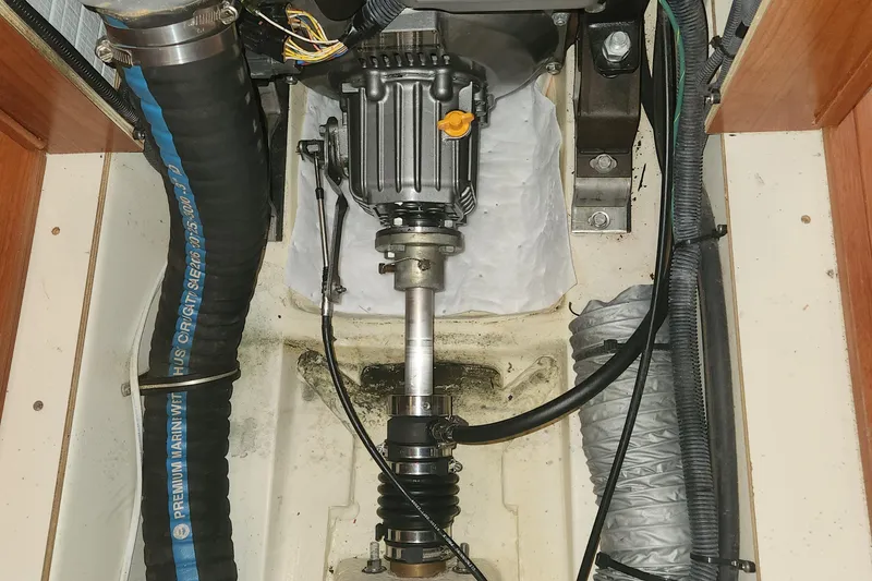 Slide: The Image of Engine compartment of a 2011 Hunter 39 sailboat, featuring mechanical components and hoses. - 20