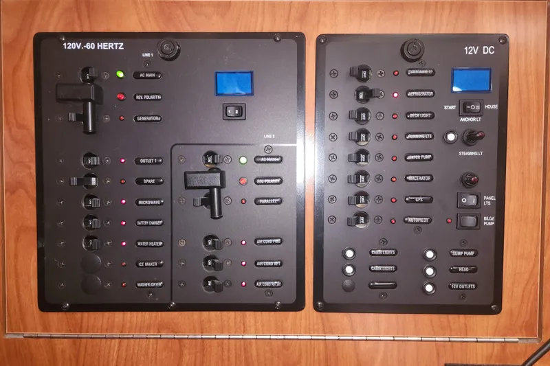 Slide: The Image of Electrical control panel of a 2011 Hunter 39 boat, featuring 120V and 12V systems. - 23