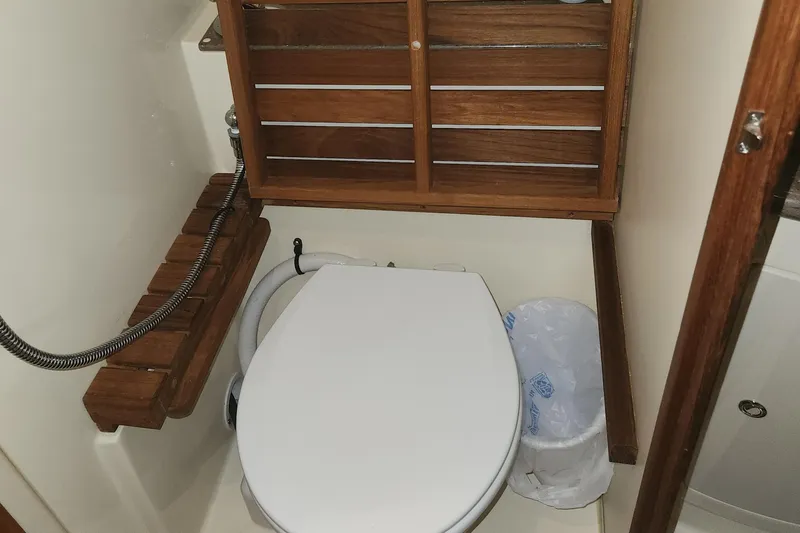 Slide: The Image of Compact bathroom in 2011 Hunter 39 sailboat with wooden accents and toilet. - 28