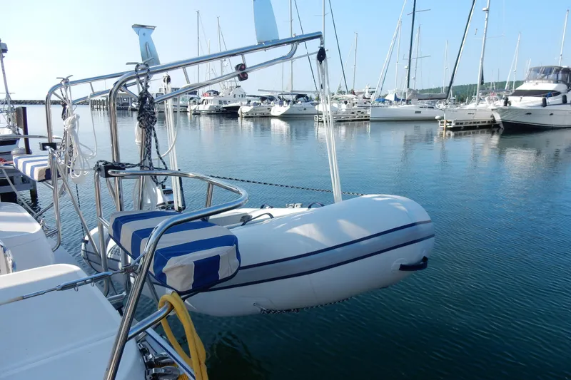 Slide: The Image of Sailboat Hunter 39 (2011) docked with dinghy, surrounded by other boats in marina. - 29