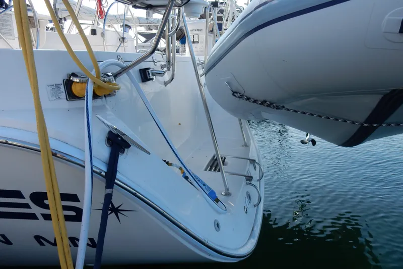 Slide: The Image of 2011 Hunter 39 sailboat stern with dinghy, docked in marina. - 32
