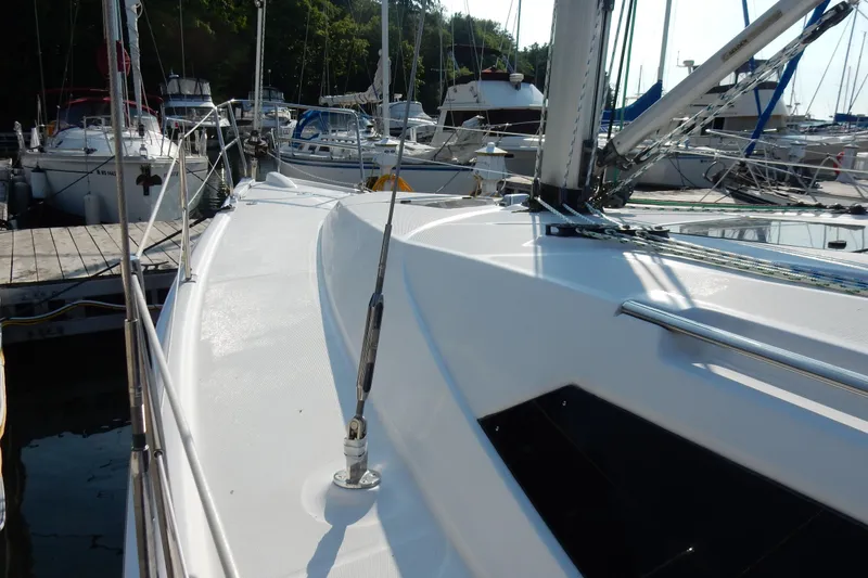 Slide: The Image of 2011 Hunter 39 sailboat docked at marina, showcasing sleek deck design. - 34