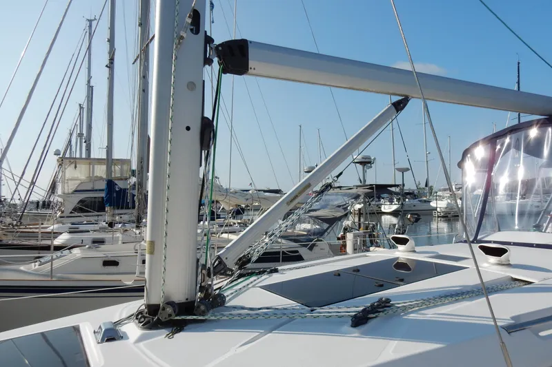 Slide: The Image of 2011 Hunter 39 sailboat docked in marina, surrounded by other boats. - 35