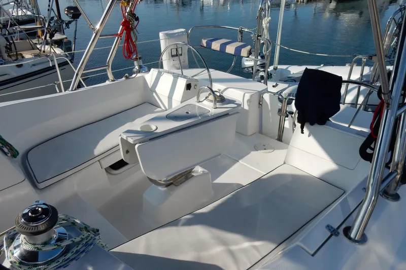 Slide: The Image of 2011 Hunter 39 sailboat cockpit with seating, winch, and marina view. - 36