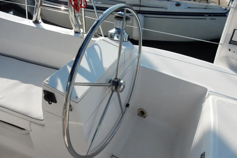 Slide: The Image of Steering wheel of a 2011 Hunter 39 sailboat, featuring a sleek, modern design. - 45