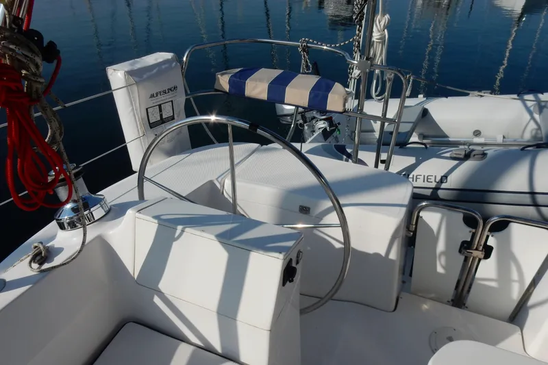 Slide: The Image of Cockpit of 2011 Hunter 39 sailboat with steering wheel and lifebuoy. - 50
