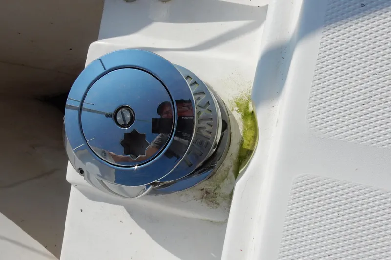 Slide: The Image of Chrome winch on 2011 Hunter 39 sailboat deck, with visible reflection and slight algae growth. - 55