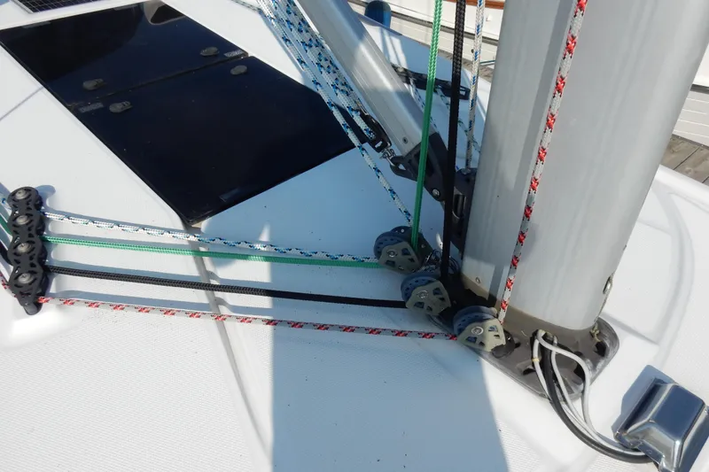 Slide: The Image of Sailboat rigging on a 2011 Hunter 39, featuring colorful ropes and pulleys. - 57