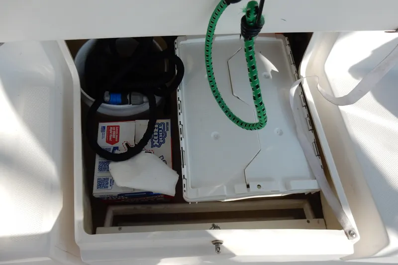 Slide: The Image of Storage compartment in a 2011 Hunter 39 boat with cleaning supplies and equipment. - 63