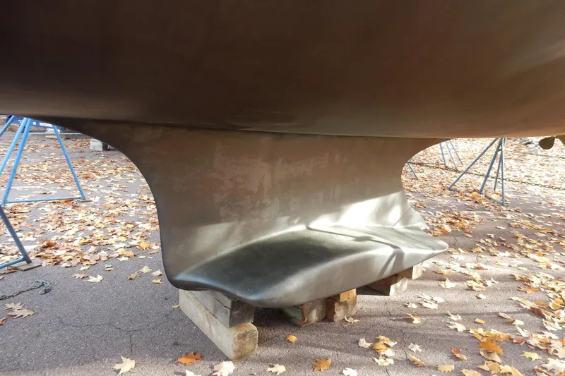 Slide: The Image of Keel of 2011 Hunter 39 sailboat on blocks, surrounded by autumn leaves. - 71