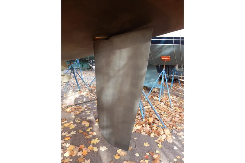 Slide: The Image of Rudder of a 2011 Hunter 39 sailboat on a stand with autumn leaves. - 74