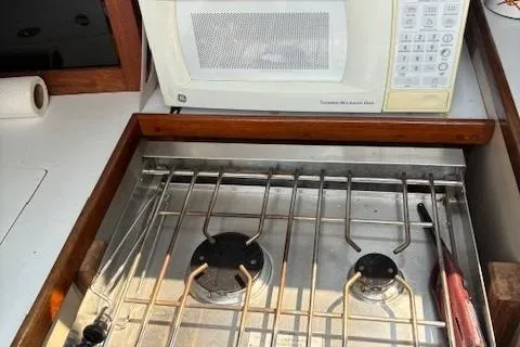 Slide: The Image of Galley kitchen in 1984 Catalina 38 sailboat with stove and microwave. - 10