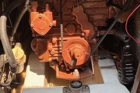 Slide: The Image of Engine compartment of a 1984 Catalina 38 sailboat, showcasing mechanical components. - 11