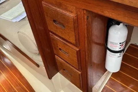 Slide: The Image of Wooden interior of 1984 Catalina 38 sailboat with drawers and fire extinguisher. - 13