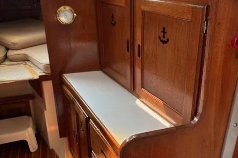 Slide: The Image of 1984 Catalina 38 yacht interior with wooden cabinets and nautical decor. - 2